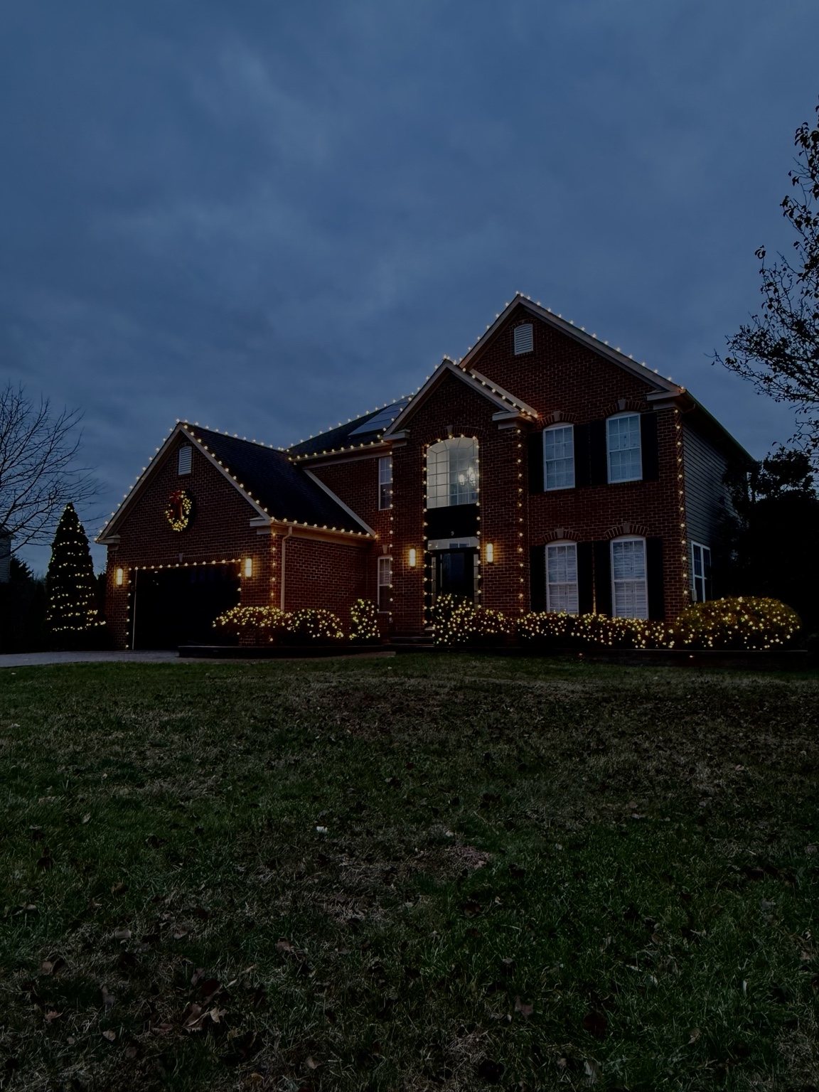 Holiday lighting installation on a brick home in Cape May Court House NJ